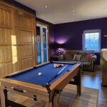 Office with workspace and pool table